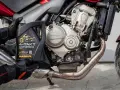 Rękawice motocyklisty trzymają olej Mannol 4-Takt Motorbike SAE 10W-40. Jaki olej do motocykla? Ten zapewni płynną pracę silnika Honda.
