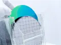 A gloved hand holds a silicon wafer, its grid pattern visible. Another wafer, iridescent blue and green, rests behind it. This image explores the question: is plastic a semiconductor?