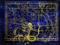 Mapa estelar dorado sobre fondo azul. Representa constelaciones y la eclíptica, clave para entender qué es el ascendente en la carta astral.