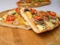 Dwie pyszne pizze na bagietce z pomidorami, pieczarkami i serem. Idealne na szybki obiad.