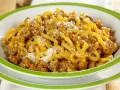 Piatto di gramigna alla salsiccia, condita con ragù saporito e una spolverata di parmigiano.