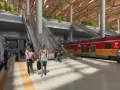 Nowoczesny dworzec kolejowy z pociągiem POLREGIO, pasażerami i schodami ruchomymi.