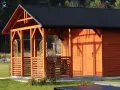 Drewniany dom szkieletowy z werandą i czarnym dachem, otoczony zieloną trawą.