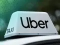 Uber Taxi-Schild auf einem Auto. Werden Sie jetzt Uber Partner und starten Sie Ihre Karriere!