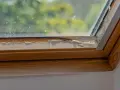 Damaged wooden frame of a skylight showing signs of water damage, indicating a need for skylight leak repair.