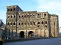 The Porta Nigra, a magnificent example of Trier Roman ruins, stands tall with its imposing stone structure and arched gateways.