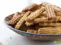 Stos ciasteczek w misce, idealnych do kawy. Pyszny przepis na ciastka, który warto wypróbować.