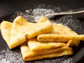Délicieuses crêpes dorées, saupoudrées de sucre glace, prêtes à être dégustées. La pâte à crêpe Thermomix, un jeu d'enfant !