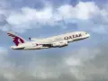 Qatar Airways Airbus A380 airplane in flight against a cloudy blue sky.