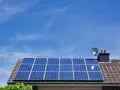 Panele fotowoltaiczne na dachu domu, symbolizujące długą żywotność i ekologiczne pozyskiwanie energii.