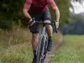 A cyclist rides on a gravel path, showing how many calories 10 minutes of cycling burns.