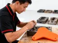 A technician works on a mold, a key step in rapid tooling.