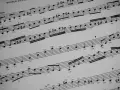 Fragment nutowy z zaznaczonym "Legato" i cyframi "3" nad grupami nut, typowy takt 2/4 przykład.
