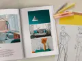 Otwarta księga prezentuje inspiracje do wzornictwa studia: projekt wnętrza i szkice modowe.