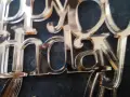 Close-up of a "Happy Birthday" acrylic mirror cake topper, showing the delicate edges and some minor imperfections from how to cut acrylic mirror.
