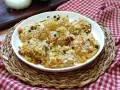 Deliziose cipolle al forno, dorate e croccanti, guarnite con rosmarino e pepe nero. Un contorno saporito e invitante.