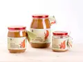 Tre barattoli di pasta di nocciola Piemonte IGP, con etichette raffiguranti uno scoiattolo.