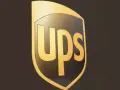 Logo UPS dorato su sfondo scuro. Informazioni sullo stipendio corriere UPS.
