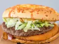 Burger Drwala z serem, sałatą, bekonem i panierowanym kotletem.