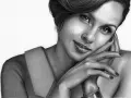 Portrait au crayon d'une femme au visage asymétrique, le regard intense, la main posée sur la joue, un sourire énigmatique.