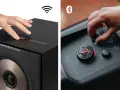 Hände bedienen Lautsprecher. Ein Lautsprecher zeigt ein WLAN-Symbol, der andere ein Bluetooth-Symbol. So funktioniert Bluetooth: kabellose Verbindung für Musik.