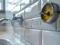 Robinet de salle de bain encastrable avec une graduation indiquant la hauteur. Un indicateur jaune est visible.