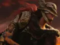 Malenia, la Espada de Miquella de Elden Ring, con su armadura dorada y cabello rojo, se alza contra un cielo anaranjado.