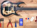E-Gitarre aufbau: Werkzeuge, Plektren, Stimmgerät-App und ein Inbusschlüssel liegen bereit.