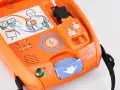 Pomarańczowy defibrylator AED z instrukcją użycia i wskaźnikami.