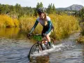 Moriah Wilson splashes through a river on her bike, a challenging part of the race. Kaitlin Armstrong might have faced similar obstacles.