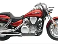 Czerwony motocykl Honda VTX 1300 z chromowanymi elementami i potężnym silnikiem V-twin.