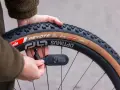 Checking the mountain bike tire pressure with a digital gauge. The tire reads 27.3 PSI.