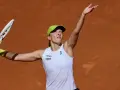 Linda Noskova w akcji, przygotowuje się do potężnego serwisu na ceglanym korcie.