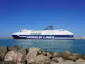 Prom Grimaldi Lines wypływa z Livorno do Palermo. Statek "Cruise Sardegna" na tle błękitnego nieba i morza.