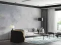 Nowoczesny salon z sofą, stolikami i dywanem. Ściana za sofą ma subtelny **efekt betonu**, nadając wnętrzu industrialny charakter.