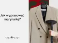 Jak wyprasować marynarkę? Ręka trzyma parownicę, która usuwa zagniecenia z beżowej marynarki.