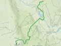 Mapa turystyczna z zaznaczoną trasą w Kalwarii Pacławskiej. Widoczna rzeka, wzgórza i ścieżki.