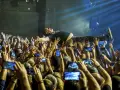 Kult w Arahji: wokalista zespołu niesiony przez tłum, fani nagrywają koncert telefonami.