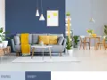 Nowoczesny salon z szarą kanapą, żółtymi poduszkami i kocem. Ściany w odcieniach niebieskiego koloru ścian tworzą przytulną atmosferę.