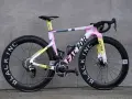 A stylish pink, yellow, and grey Factor road bike, perfect for women beginners looking for a fun and fast ride.