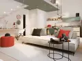 Soggiorno moderno con cucina a vista, ideale per chi cerca un bonus ristrutturazione case vecchie. Tavolini neri, divano chiaro, pouf rosso.