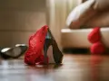 Czerwona koronka i czarny szpilka na podłodze. Seksowna bielizna i buty, które podpowiedzą, jak podniecić faceta.
