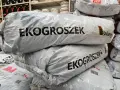 Stos worków z napisem Eko Groszek. Sprawdź aktualną eko groszek cena i wybierz najlepszą ofertę.