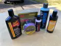 Car scratch removal products, including rubbing compound, are laid out, ready to tackle paint scratches and swirls.