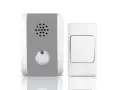 Un timbre inalámbrico para casa, con un receptor gris y blanco y un pulsador blanco.