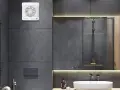 Extractor de baño blanco instalado en pared de azulejos grises.