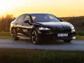 Czarny Skoda Superb 4 na tle zachodzącego słońca. Elegancki sedan z nowoczesnymi światłami i felgami.