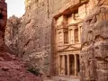 The Treasury in Petra, Jordan, emerges from a narrow canyon. It's a long journey, but how far is Petra from Amman? This ancient city is worth the trip.