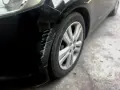 Scratches mar the black paint on a car's fender. Learn how to get scratches out of black car paint to restore its shine.