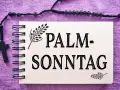 Ein Notizbuch mit der Aufschrift "PALM-SONNTAG" und einem Rosenkranz mit Kreuz. Gesegneten Palmsonntag!